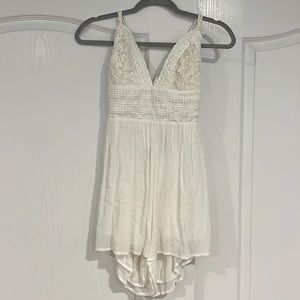 The brand is ILLA ILLA, medium size, white romper